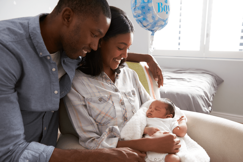 Image: Couple holding thier baby