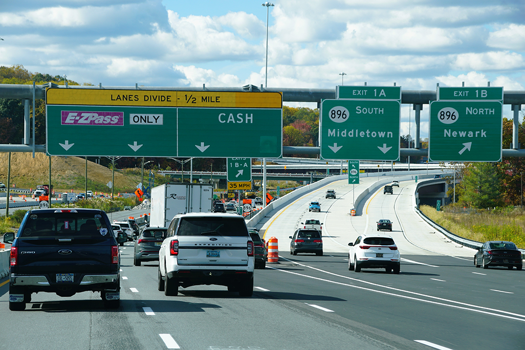 Cars driving on a highway with road signs